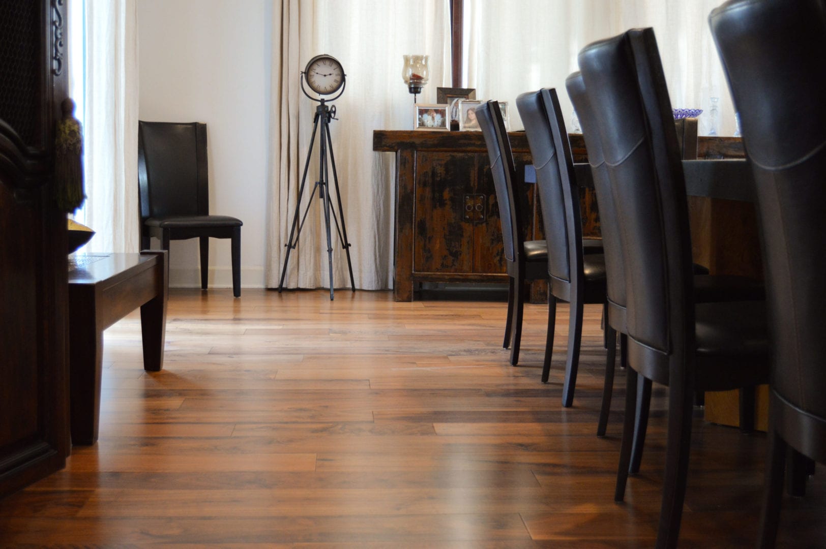 a room with chairs on hardwood flooring