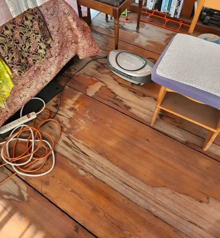 Worn wooden floor before repair and refinishing